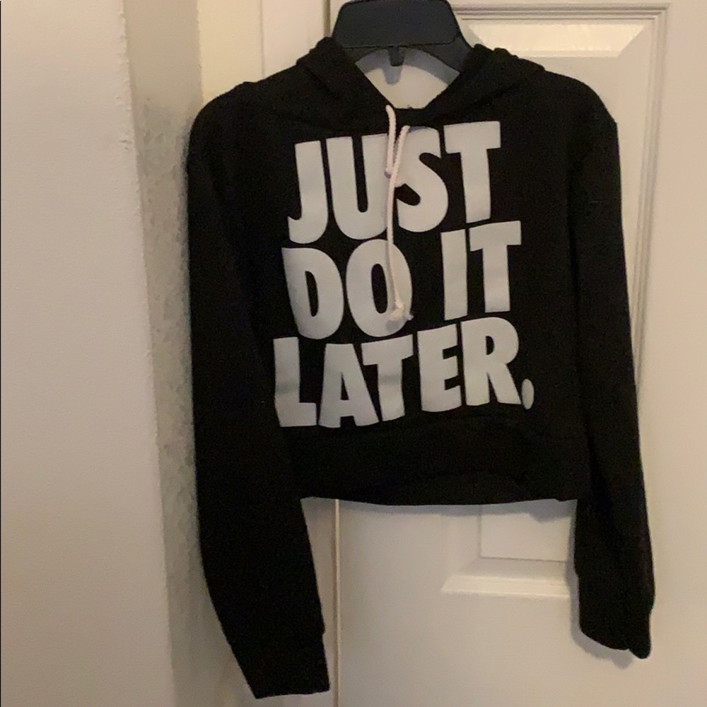 A black crop top that says “just do it later”